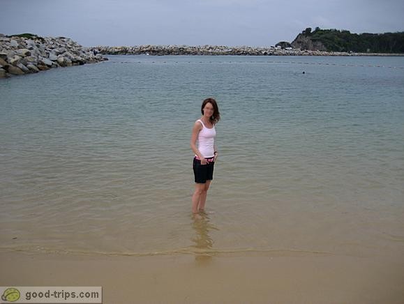 Tourist is cooling legs at Narooma beach